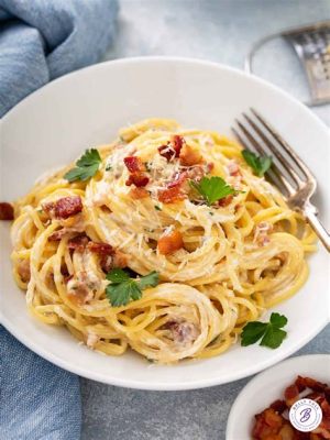  Spaghetti alla Carbonara:  A symphony of savory silkiness and creamy decadence on your palate! 